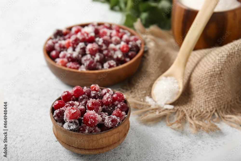 Bowls with tasty sugared cranberries on white background Bowls with tasty sugared cranberries on white background
