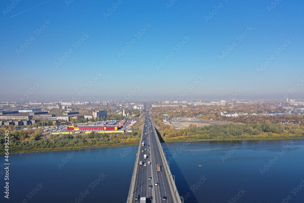 Transport bridge across the river. Nizhny Novgorod, Myzinsky bridge. Aerial photography of the river, and the bridge over the river from a drone.