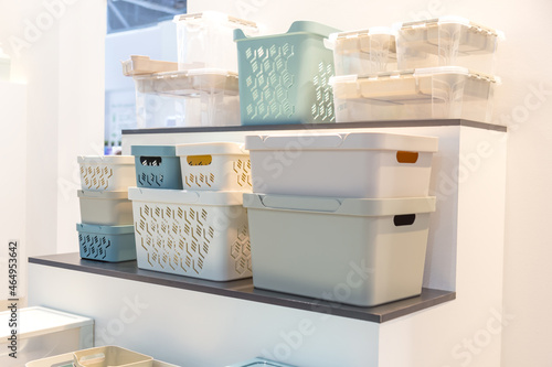 Plastic containers on a shelf for organizing home space, order and interior, sale of household goods photo