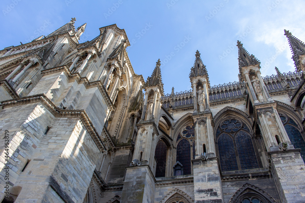 Close up view of the ornate medieval Our Lady of Reims Cathedral (Notre-Dame de Reims) in France, with high Gothic architecture, showing its flying buttresses