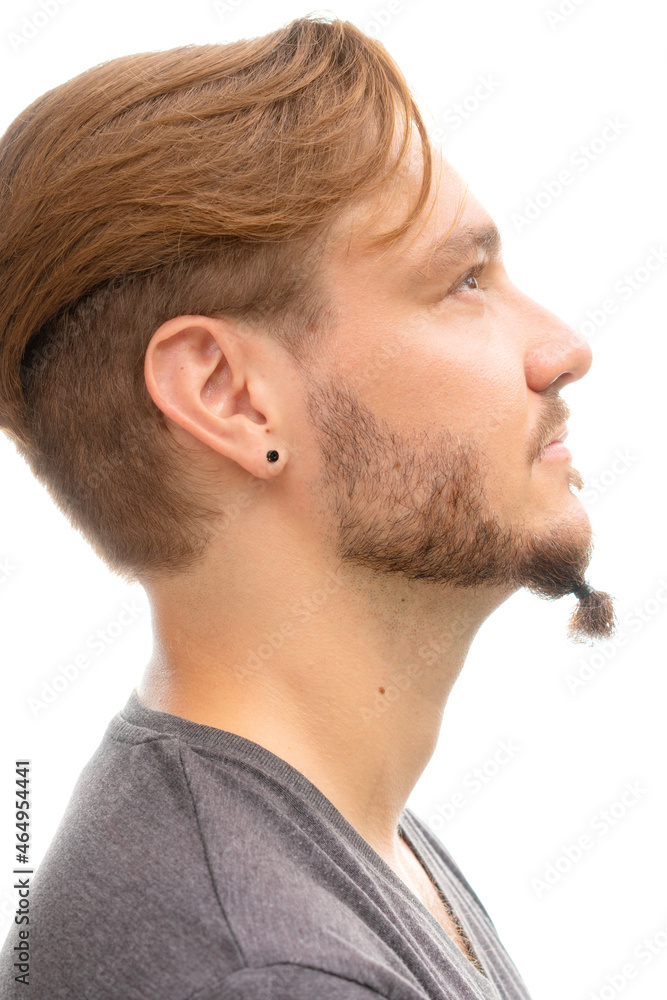 A profile portrait of a stylish man with a piercing A profile portrait of a stylish man with a piercing