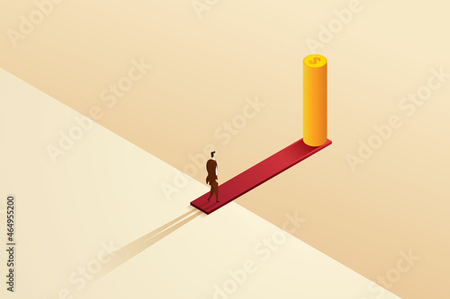 Businessman walks on a wooden board on the edge of a cliff to a pile of coins.