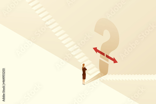Businesswoman stands at a crossroads with a large shadowed question mark.