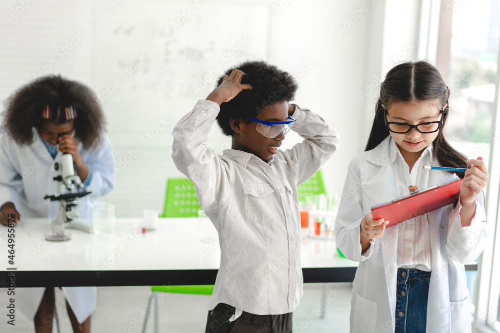 Group of teenage cute little student child learning research and doing a chemical experiment while making analyzing and mixing liquid in test tube at experiment laboratory class at school.Education Group of teenage cute little student child learning research and doing a chemical experiment while making analyzing and mixing liquid in test tube at experiment laboratory class at school.Education