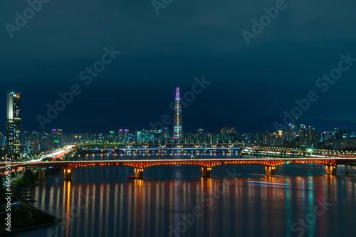 Night view of Lotte tower the fifth tallest building skyscraper in the world along with Han Gang river of Seoul South Korea © Huzfilm