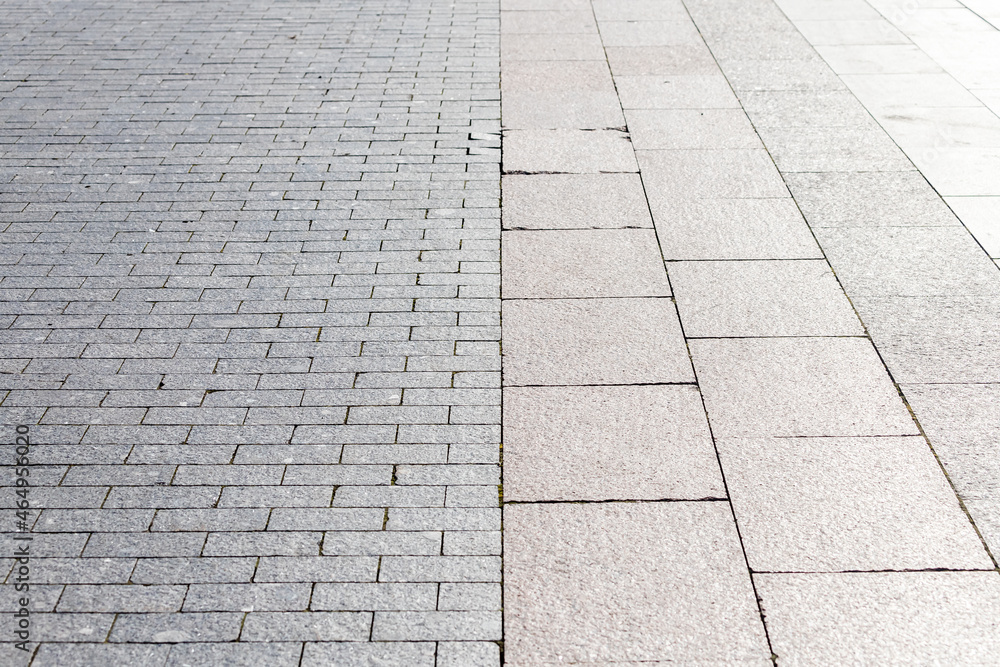 Fototapeta premium The road is paved with gray stones, top view. stone texture, outdoor stone tiles