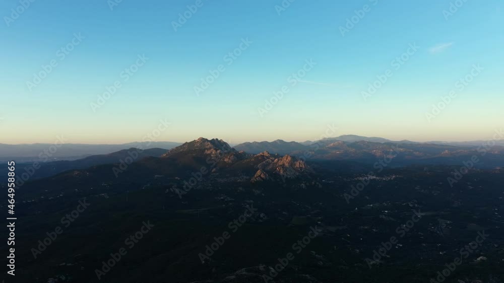 View from above, stunning aerial view of a mountain range illuminated by a beautiful sunrise. San Pantaleo, Sardinia, Italy. View from above, stunning aerial view of a mountain range illuminated by a beautiful sunrise. San Pantaleo, Sardinia, Italy.