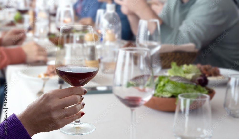 hand holding wine glass in vineyard hand holding wine glass in vineyard