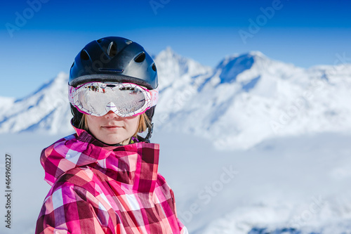 Portrait of young woman in helmet. Ski in winter time. Winter vacation in Swiss Alps. © olyphotostories