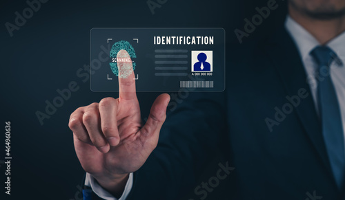 Businessman wearing black suit and hand touch interface scanning fingerprint to unlock, Concept security in identity technology.