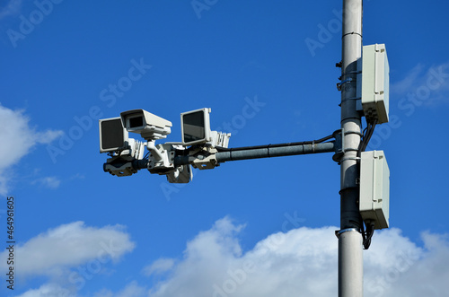 a camera system monitoring the speed of traffic vehicles on the city motorway ring. the fine comes by mail to anyone who exceeds the speed limit. two cameras in two directions photo
