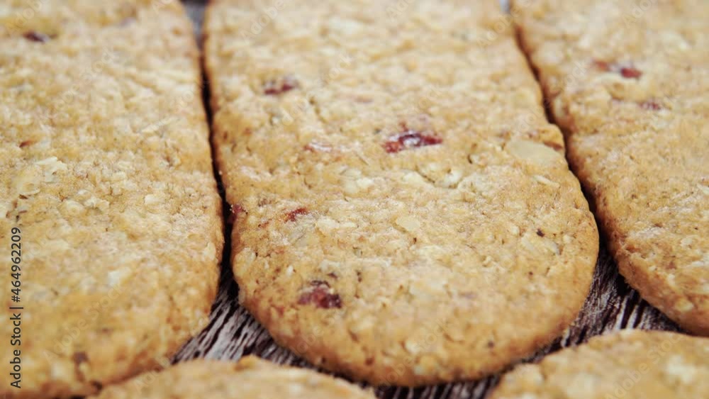 Oatmeal cookies with cranberries stacked on the board. Close up. Rotation Oatmeal cookies with cranberries stacked on the board. Close up. Rotation