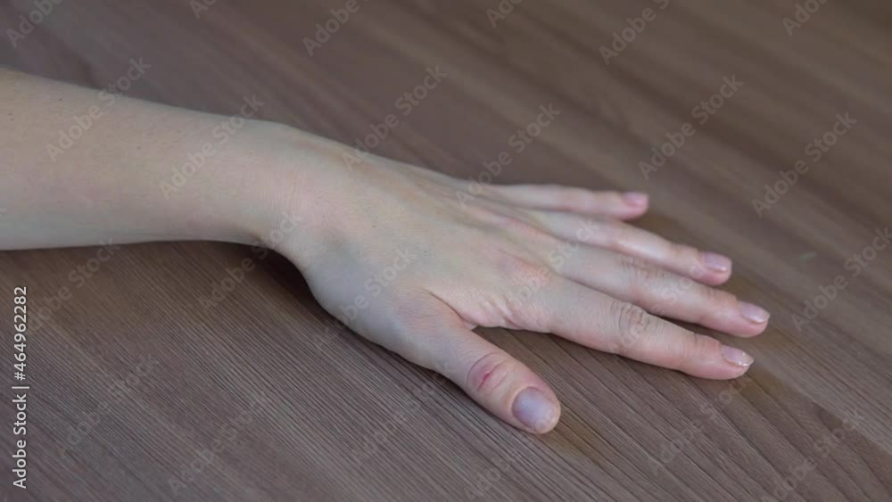 Woman hand palm is touching dark wood table countertop kitchen surface. Woman hand palm is touching dark wood table countertop kitchen surface.