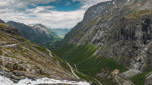 Trollstigen, Andalsnes, Norway. Stigfossen Waterfall Near Serpentine Mountain Road Trollstigen. Famous Norwegian Landmark And Popular Destination. Norwegian County Road 63 In Summer Day. 4K photo