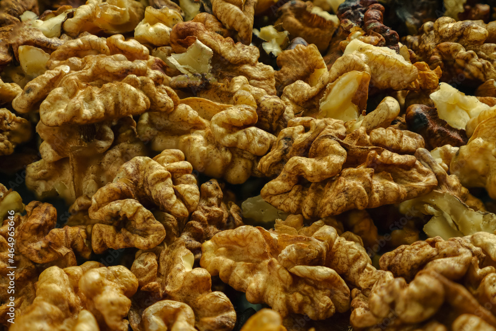 A pile of peeled walnuts in close-up. Selective focus. Background image. A pile of peeled walnuts in close-up. Selective focus. Background image.