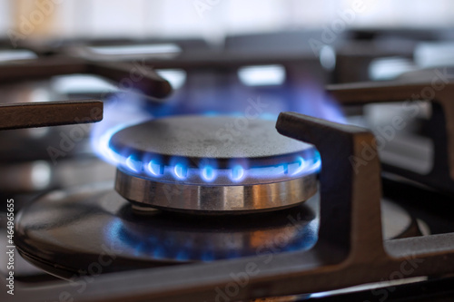 A burning gas burner on the kitchen stove. The use of natural gas for cooking.