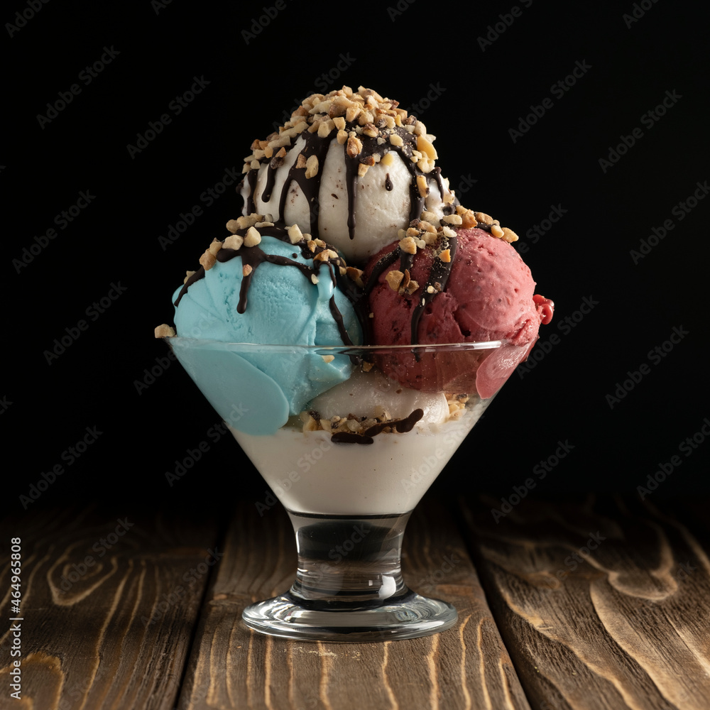 Ice cream with sauce and pistachio in a glass bowl Ice cream with sauce and pistachio in a glass bowl