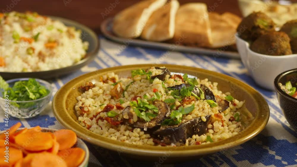 Eating greenery on bulgur with eggplant close-up, couscous with meat on background. Traditional middle eastern culture. Delicious rice with meat. Arabian cuisine. Homemade food concept. Eating greenery on bulgur with eggplant close-up, couscous with meat on background. Traditional middle eastern culture. Delicious rice with meat. Arabian cuisine. Homemade food concept.