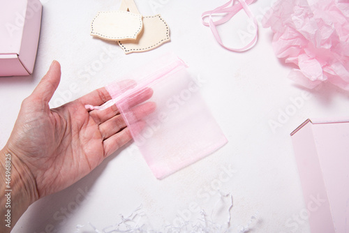 Lot of pink organza gift boxes on wooden desk