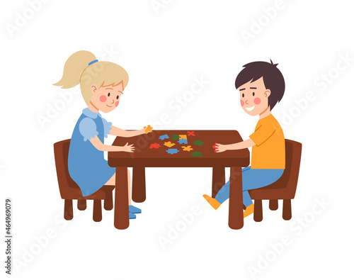 Children at table playing puzzle game, flat vector illustration isolated.