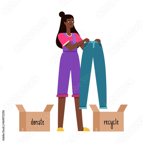 A young black girl is holding blue jeans in her hands and is thinking of donating it or recycling. Reasonable consumption, cluttering, sorting clothes. Flat vector illustration on a white background.