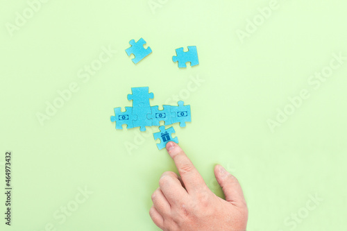 Businessman connecting pieces of a puzzle with a picture of dollars