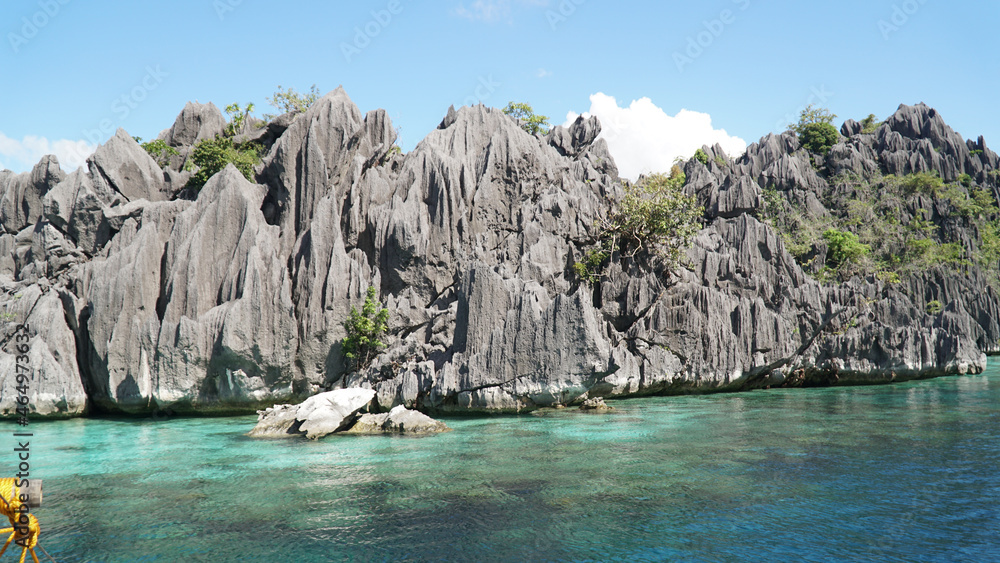 Ocean and jagged rock landscapes with turquoise water at Coron Island in Palawan, Philippines.