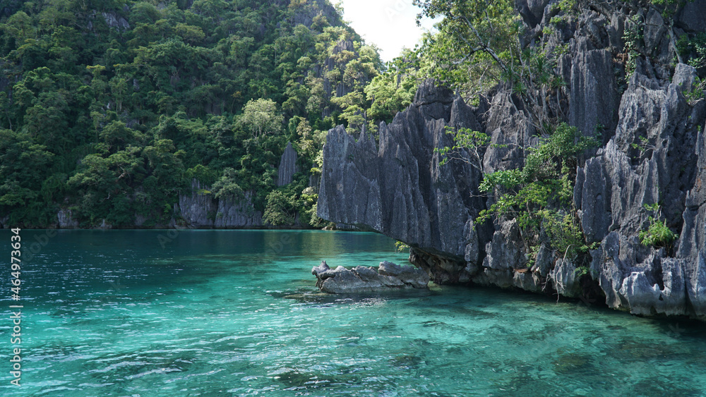 Ocean and jagged rock landscapes with turquoise water at Coron Island in Palawan, Philippines.