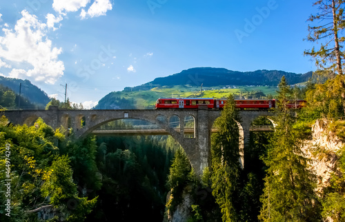 Swiss Red Train Bernina Express at Brusio Viaduct. photo