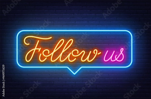 Neon Follow us up in the speech bubble on brick wall background.