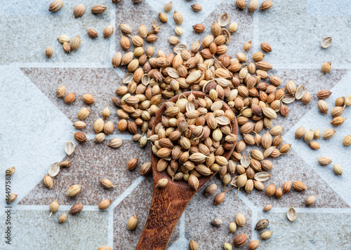 Directly Above shot of coriander seeds on wooden spoon