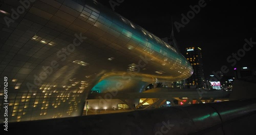 Neofuturistic Exterior Of Dongdaemun Design Plaza (DDP) In Seoul, South Korea At Night. Popular Tourist Attraction In Asia. ascending shot photo
