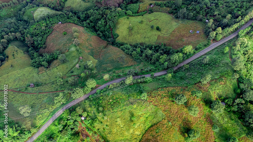 Aerial view of sky road over top of mountain with fog and green jungle after raining in morning, doi sakad, Pua, Nan, Thailand.