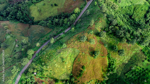 Aerial view of sky road over top of mountain with fog and green jungle after raining in morning, doi sakad, Pua, Nan, Thailand.