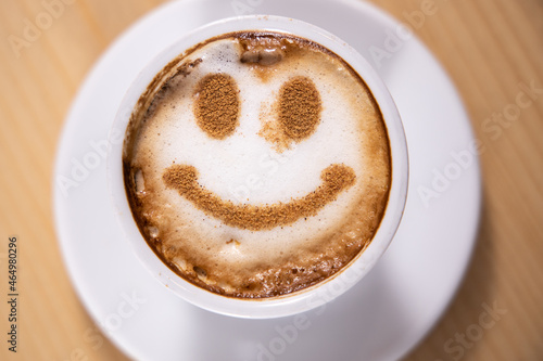 Smile of latte coffee with on wooden background. Smile face drawing on latte art coffee