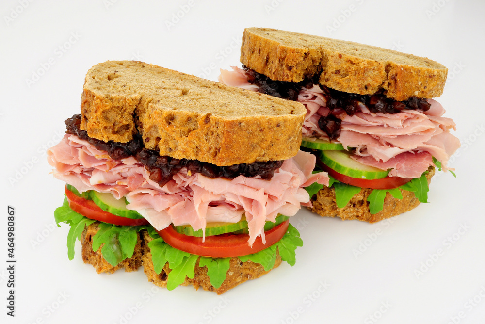 Ham and salad sandwiches In crusty brown bread slices with pickle relish Ham and salad sandwiches In crusty brown bread slices with pickle relish