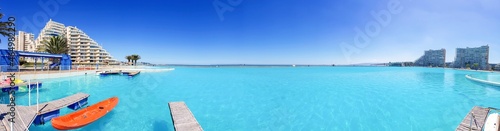 Panoramic beach behind pool in a summer day © MVH