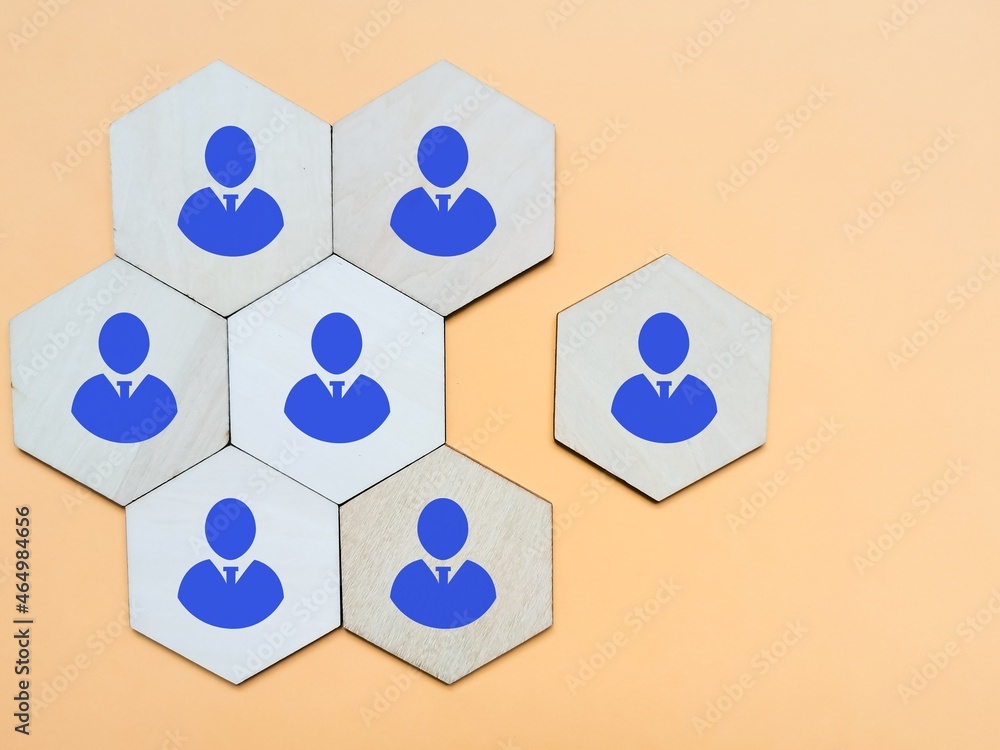 Wooden hexagon with employees icons against yellow background. Wooden hexagon with employees icons against yellow background.