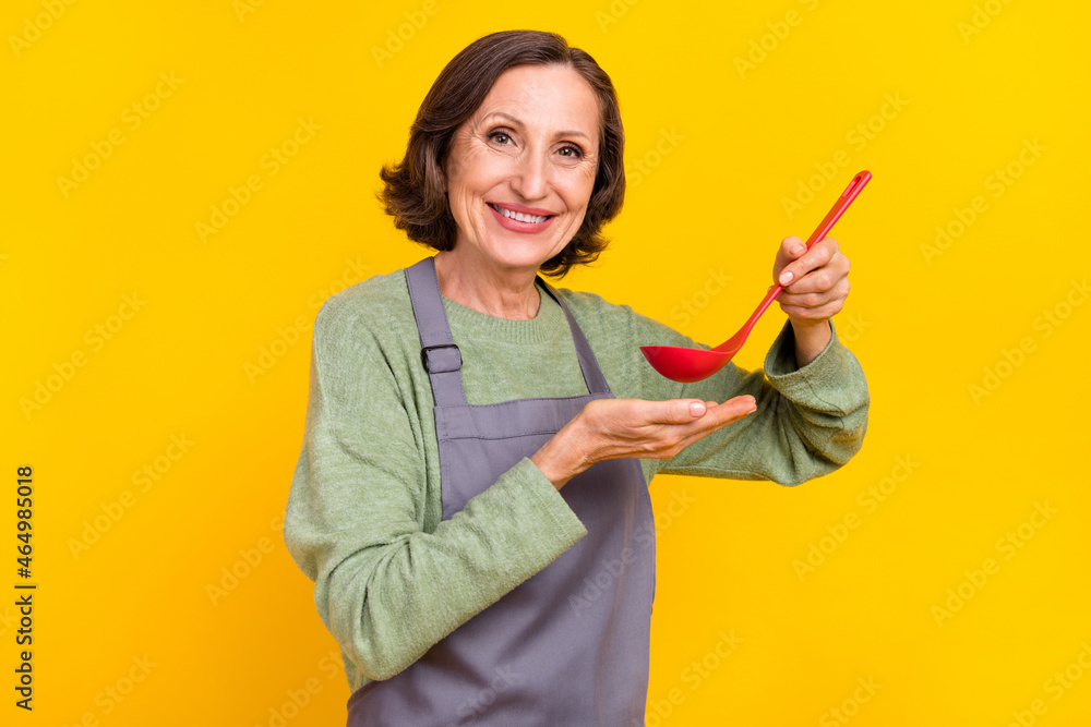 Portrait of attractive cheerful woman tasting fresh dish domestic cuisine recipe soup isolated over bright yellow color background Portrait of attractive cheerful woman tasting fresh dish domestic cuisine recipe soup isolated over bright yellow color background