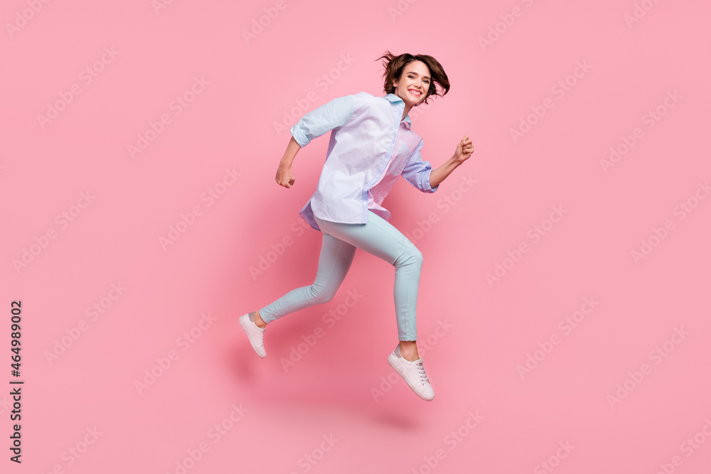 Full length body size photo woman smiling jumping up running on sale isolated pastel pink color background