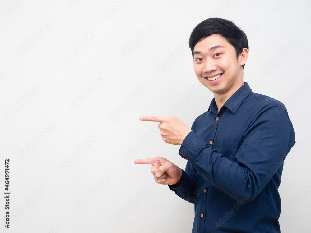 Asian man happy emotion gesture point finger at copy space white background Asian man happy emotion gesture point finger at copy space white background