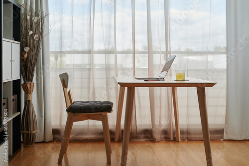 Interior of workroom with laptop on table photo