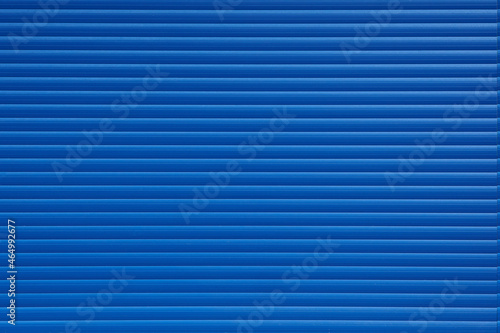 Textured background of blue wall with lines