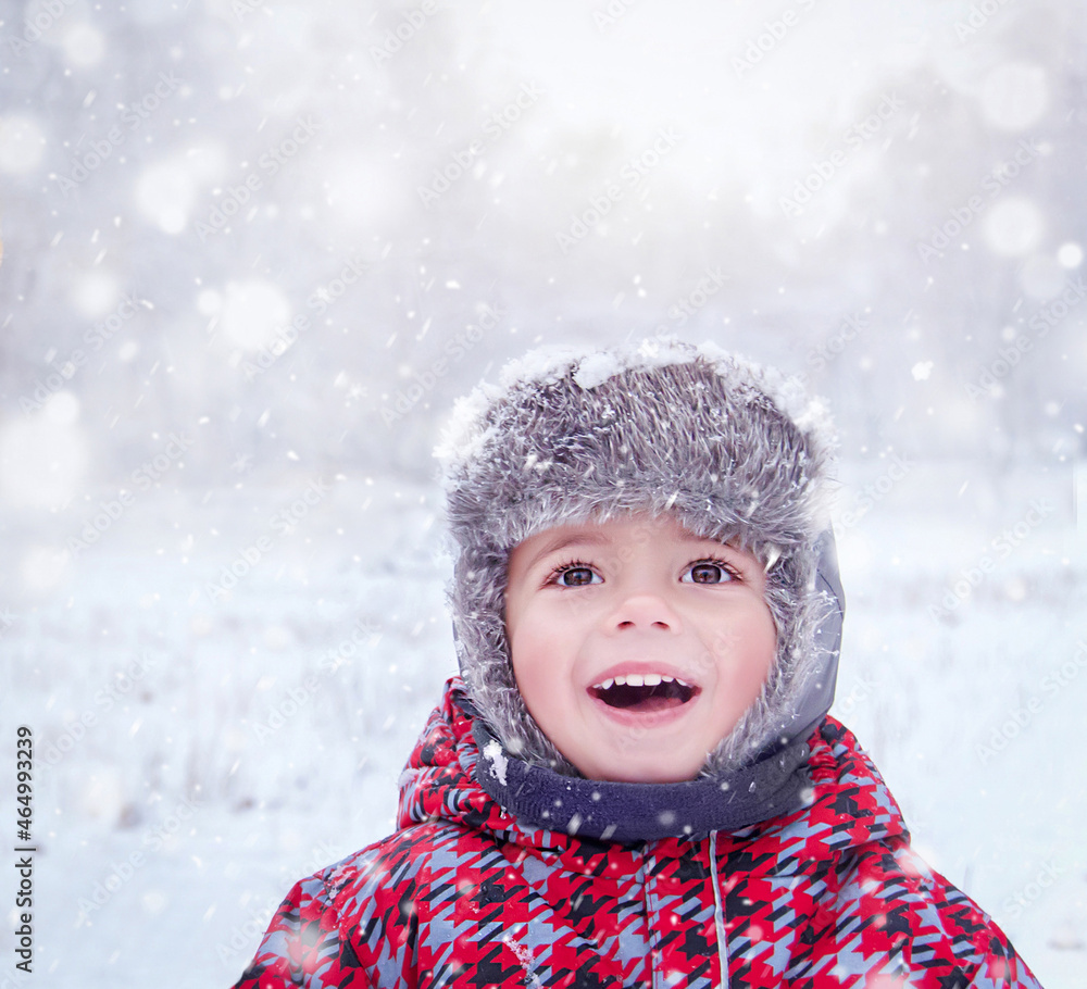 Happy child enjoying snowy day. Three years old cute smiling trendy hipster boy (kid) in winter wear. Caucasian kid playing outside. Winter, healthy lifestyle, Christmas concept. Selective focus. Happy child enjoying snowy day. Three years old cute smiling trendy hipster boy (kid) in winter wear. Caucasian kid playing outside. Winter, healthy lifestyle, Christmas concept. Selective focus.