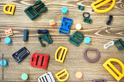 A set of colored plastic accessories for manufacture of belts, backpacks and bags photo