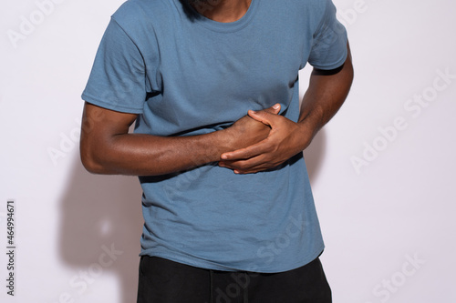 Photos ill black man holding his stomach in discomfort