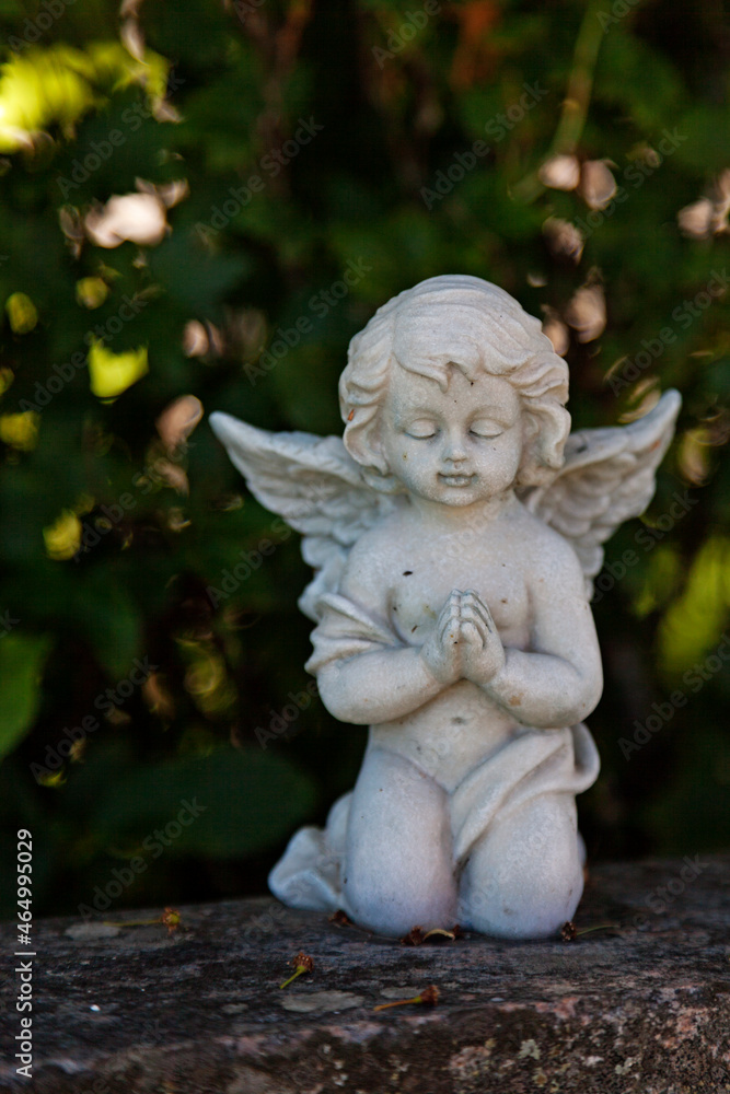 Nordmaling, Norrland Sweden - June 8, 2021: a beautiful little cherub in white stone Nordmaling, Norrland Sweden - June 8, 2021: a beautiful little cherub in white stone