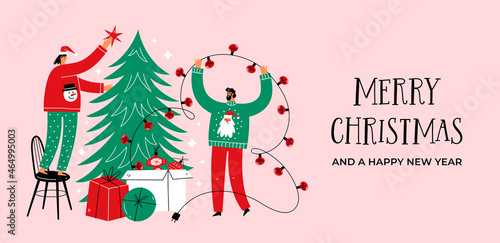 Merry Christmas and happy new year banner or landing page with happy people decorated Christmas tree together. 
