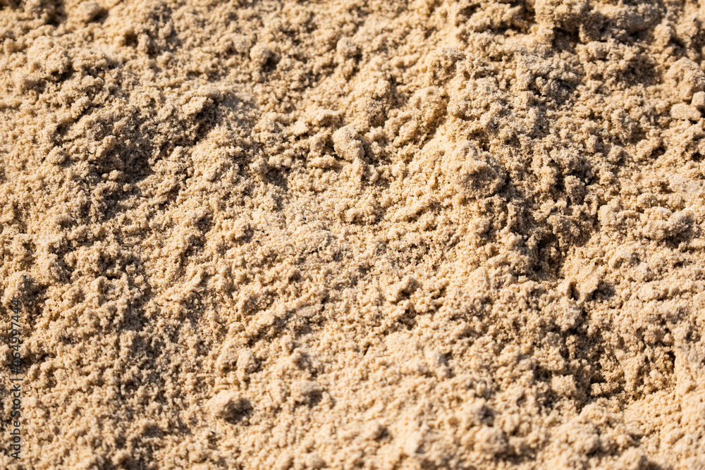 Sand textured background on the beach. Closeup.