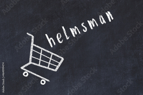 Chalk drawing of shopping cart and word helmsman on black chalboard. Concept of globalization and mass consuming